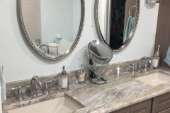Bathroom vanity with twin oval mirrors.